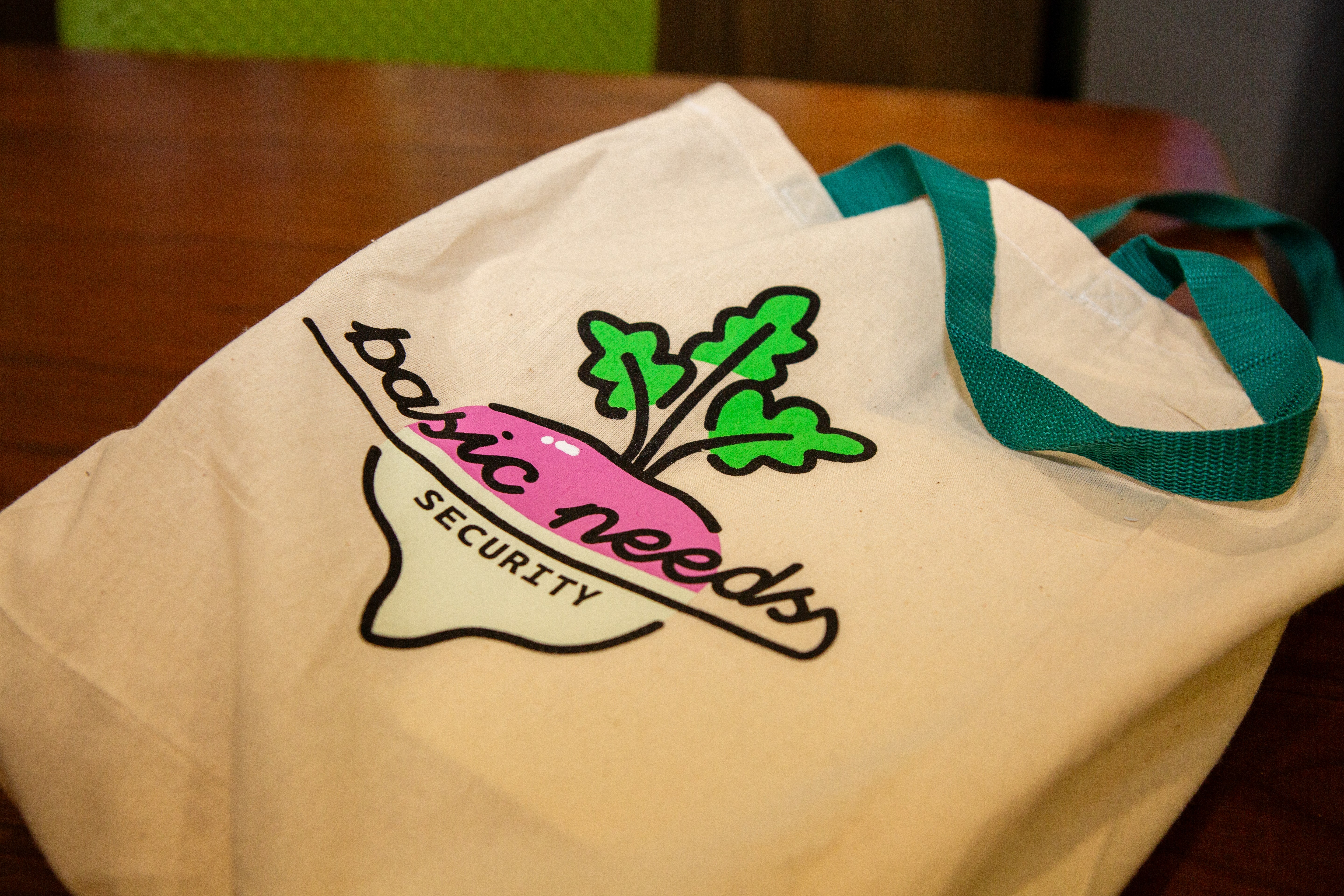 basic need tote bag laying on a flat surface